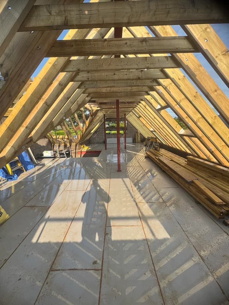 Exposed roof rafters and purlins of a large loft conversion under construction