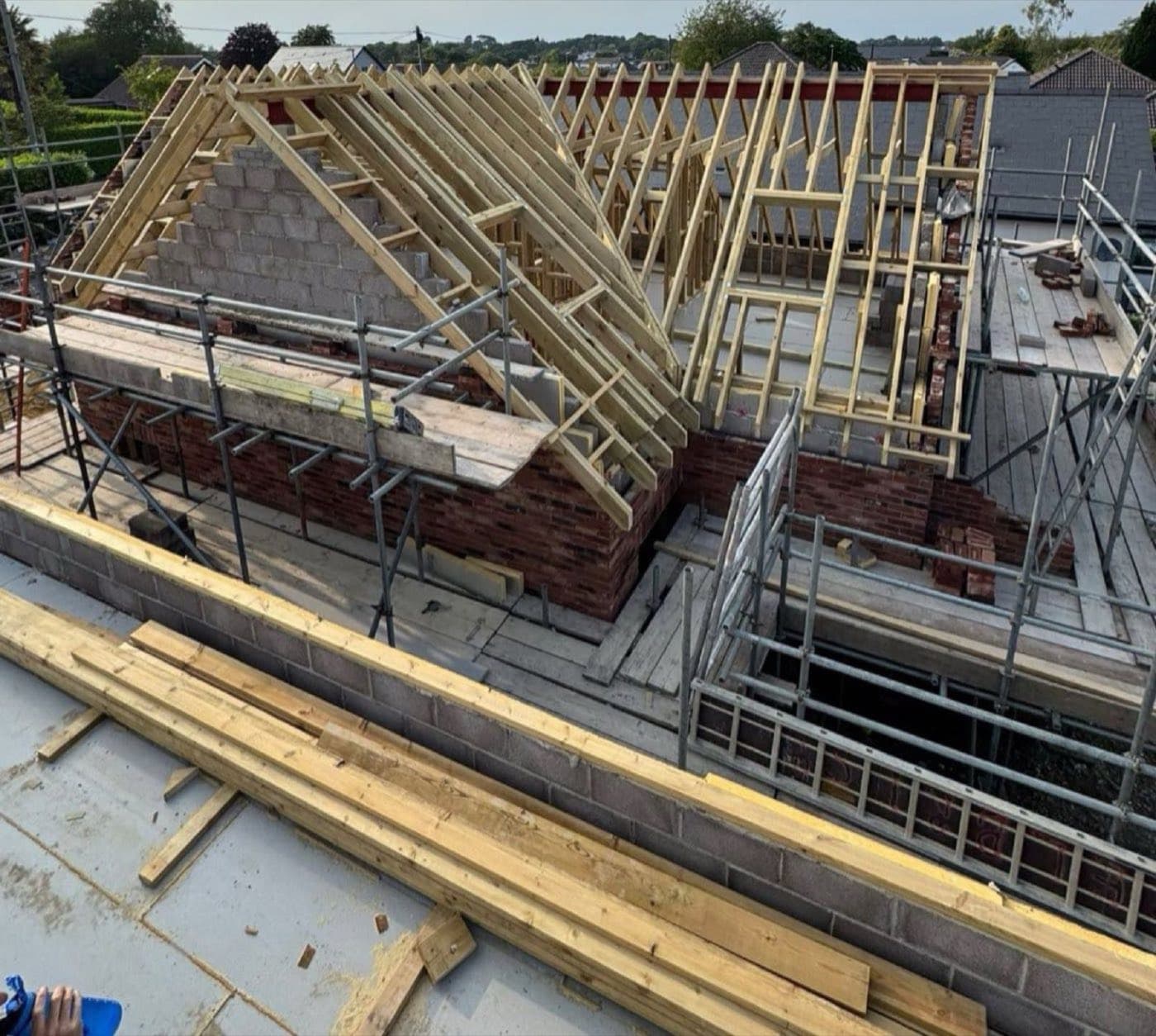 Timber roof trusses erected on a new-build house with brick and block walls