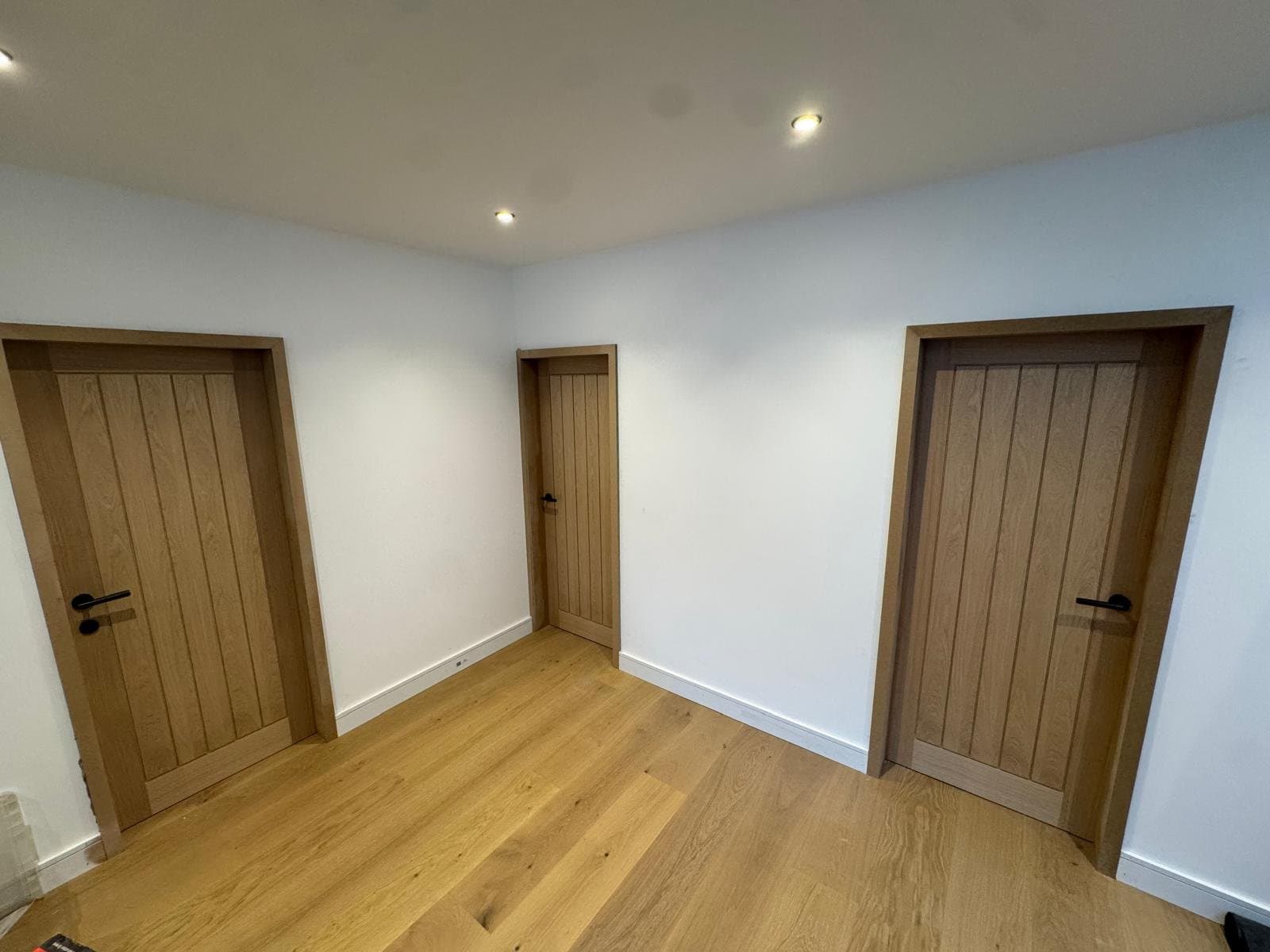 Oak cottage-style internal doors with oak linings and white skirting, fitted at second fix