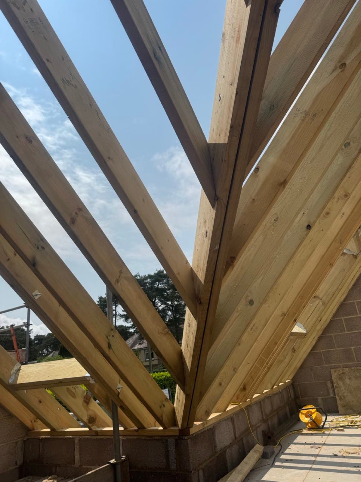 New timber hip roof rafters framed on an extension, open to the sky